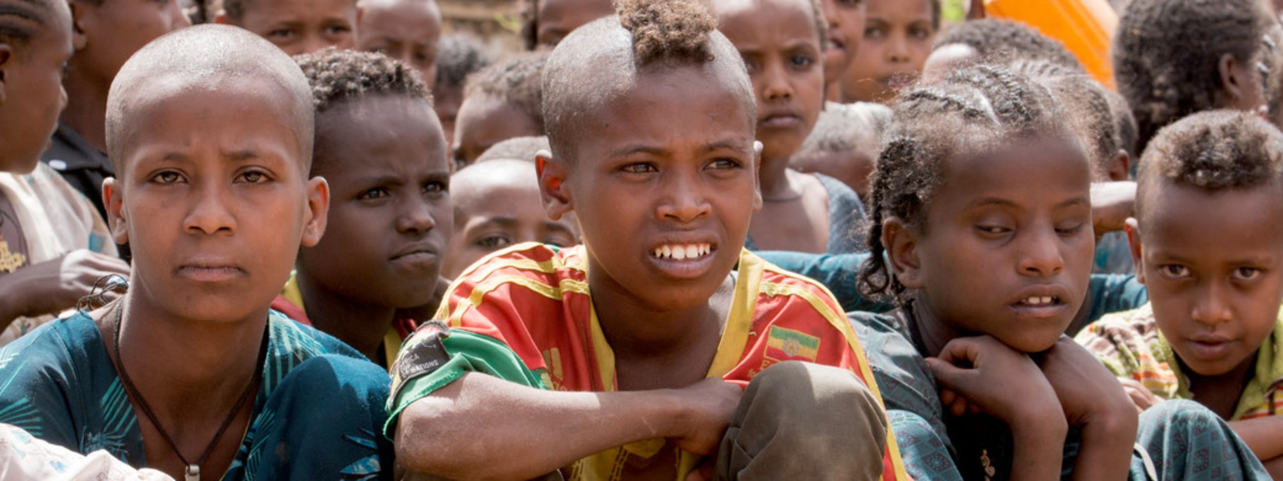 Image of people standing in lines in an open field
