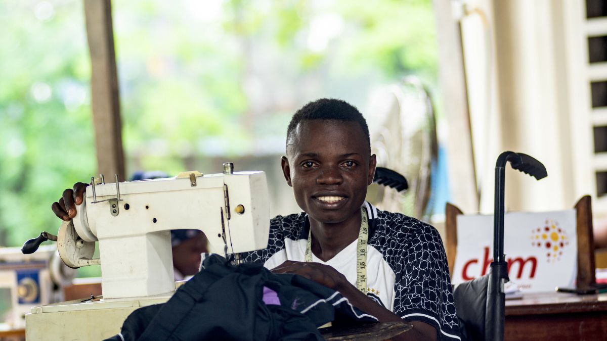 Jordan, a 25-year-old with a leg disability from wild poliomyelitis due to lacking vaccination, was identified at a Catholic parish through a CBM-funded project in Congo. He is now enrolled in a sewing training center.