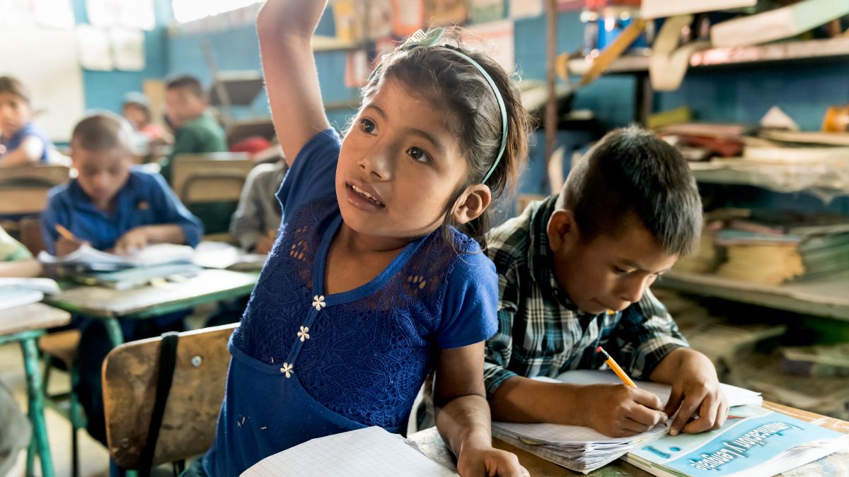 A school girl raising her hand