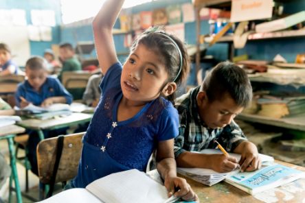 A school girl raising her hand