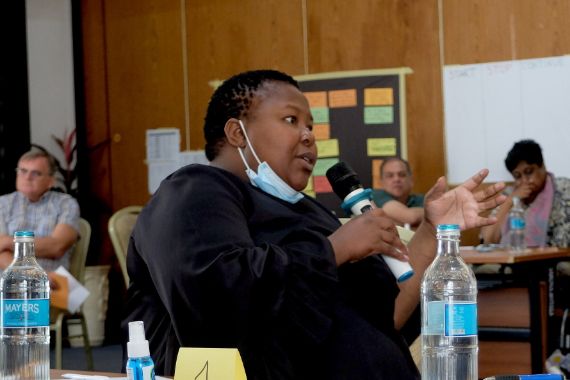 A participant asking questions in a &#039;train the trainers&#039; workshop