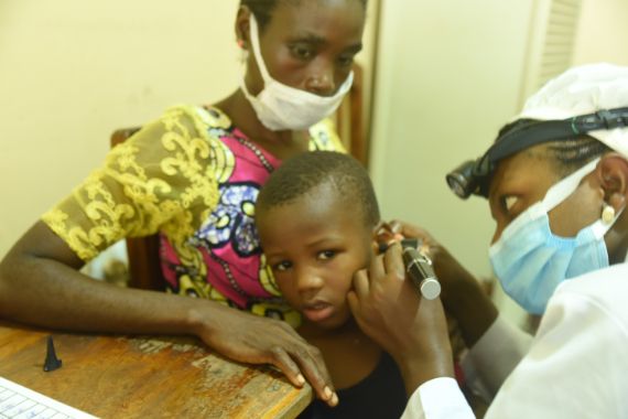 Repha is the clinical officer and audiologist at the CBC Hospital, a CBM partner hospital in Cameroon. Here, Repha is examining a patient&#039;s ear.