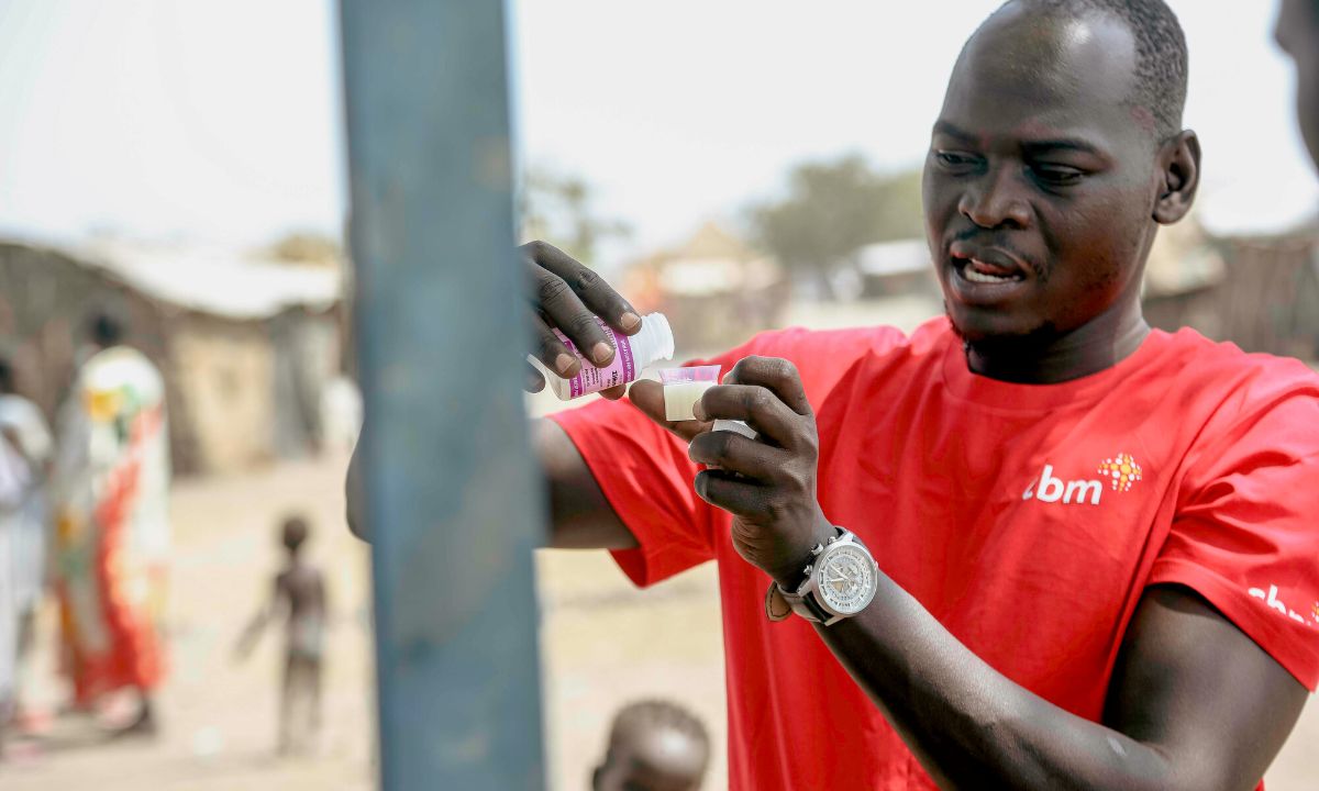 Samuel Lubari, a trachoma project officer in CBM&#039;s South Sudan country office, is preparing liquid azithromycin antibiotic to treat trachoma infection in children.