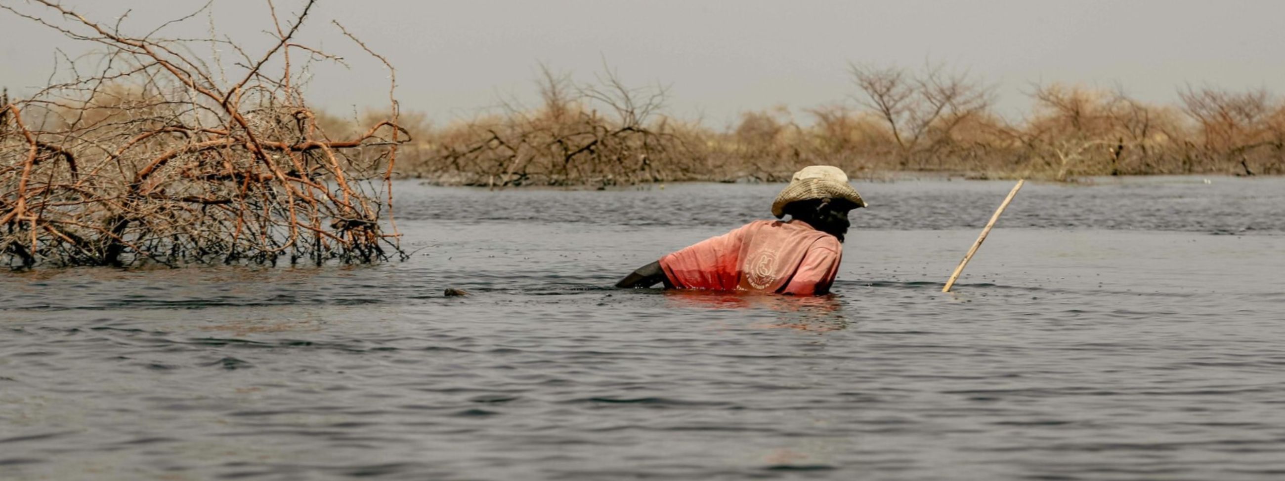 A man walking in a flooded field
