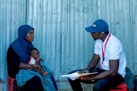 Musa Yunana Bwala, the Humanitarian MEAL Officer at CBM Nigeria, discusses the situation with Nana during a rapid assessment at Bakasi IDP Camp in Maiduguri, Nigeria. This assessment was part of efforts to provide support to people affected by flash floods in the area.