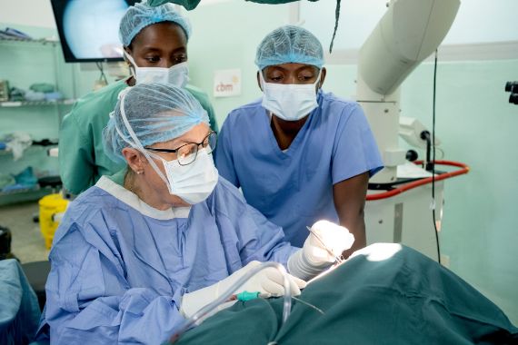 ENT specialists perform tympanoplasty surgery on a patient in an operation room.