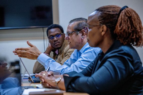 Three people in a meeting room