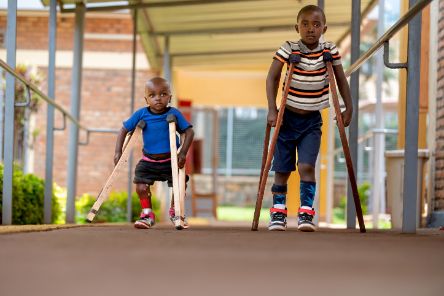 Two boys walking with clutches 