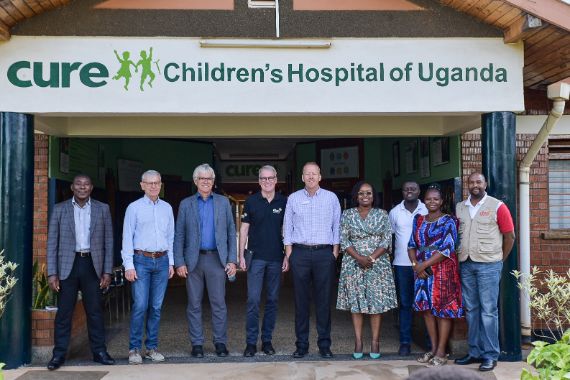 A group of partners in front of a hopsital