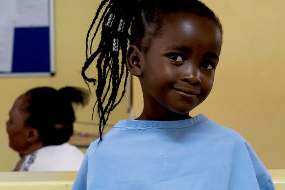 Eness, a five-year-old girl, smiles after regaining her hearing following a successful operation at the Beit Cure hospital.